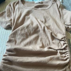 Cream blouse with strings on the side & you can stretch the shirt to your liking